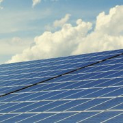 Solar panels in field with blue sky